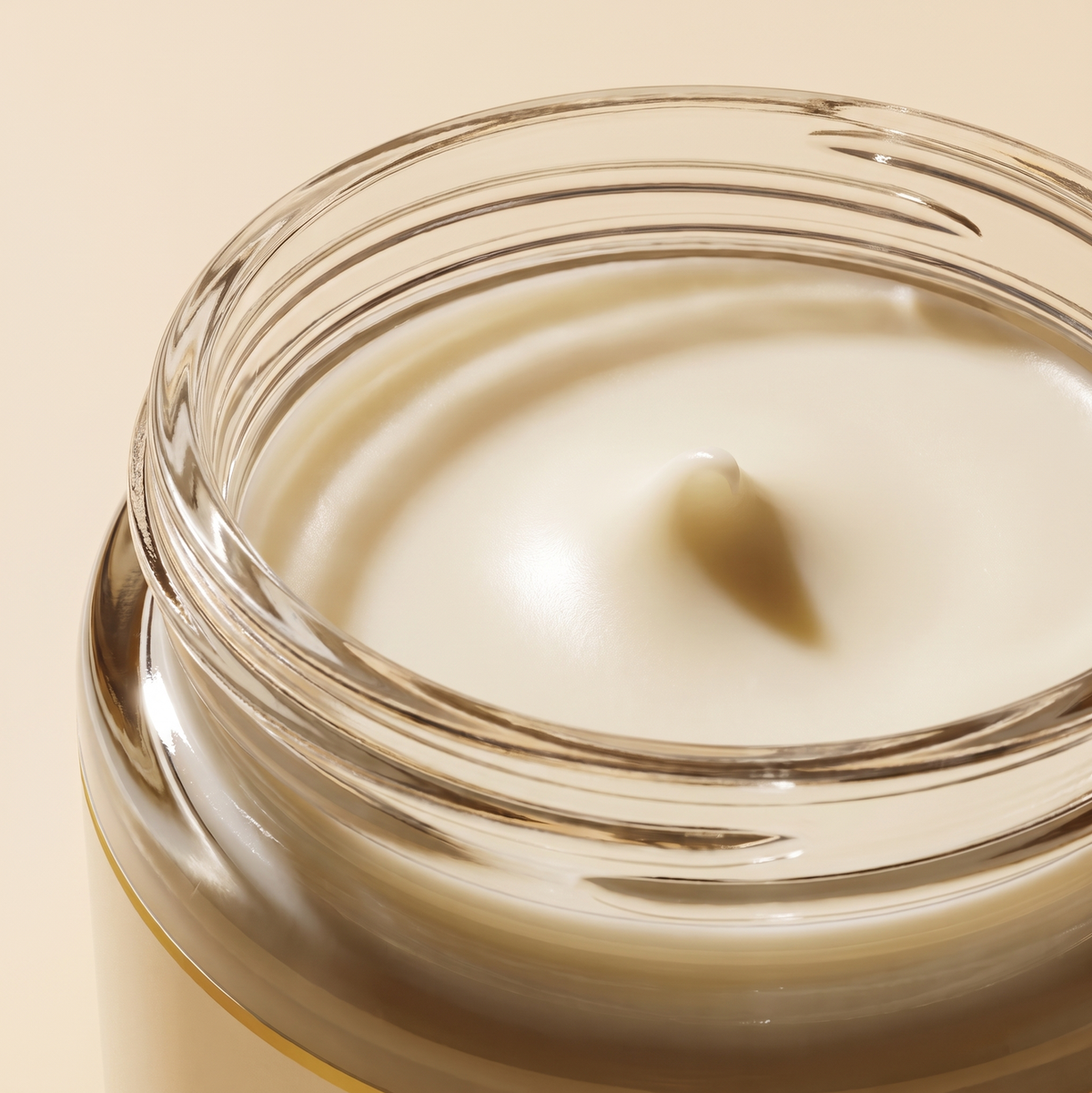 Close-up of the creamy white tallow balm inside the glass jar